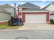 View of the two-car garage and deck area, with a red exterior at 121 Fulton Se Way, Atlanta, GA 30312