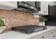 Kitchen features stone backsplash, modern appliances, and bright white countertops at 121 Fulton Se Way, Atlanta, GA 30312