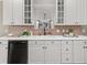 Stylish kitchen with white cabinetry, modern appliances, and a view into the living room at 121 Fulton Se Way, Atlanta, GA 30312