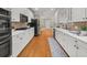 Spacious kitchen with white cabinets, stainless steel appliances, and a decorative backsplash at 121 Fulton Se Way, Atlanta, GA 30312