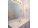 Bright bathroom featuring large mirror, white vanity with cabinet storage and dual towel rings at 1215 Harris Commons Pl, Roswell, GA 30076