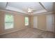 Bedroom with tray ceiling, ceiling fan, and carpet flooring at 1215 Harris Commons Pl, Roswell, GA 30076