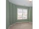 Bedroom with soft, green walls, carpeted flooring, and natural light from a window at 1215 Harris Commons Pl, Roswell, GA 30076