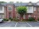 Brick townhome featuring a well maintained landscaped yard and assigned parking at 1215 Harris Commons Pl, Roswell, GA 30076