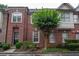 Brick townhome featuring a well maintained landscaped yard at 1215 Harris Commons Pl, Roswell, GA 30076