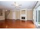 Open concept living room with hardwood floors, fireplace and sliding glass door at 1215 Harris Commons Pl, Roswell, GA 30076