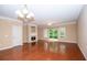 Bright living room features a fireplace, hardwood floors, and sliding glass doors to the yard at 1215 Harris Commons Pl, Roswell, GA 30076