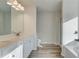 Bright bathroom featuring a double sink vanity with white cabinets and modern lighting at 349 Heavenly Hollow Pl, Mcdonough, GA 30253