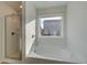 Bright bathroom featuring a soaking tub and separate glass shower with modern fixtures at 349 Heavenly Hollow Pl, Mcdonough, GA 30253