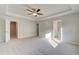 Large main bedroom with carpet and tray ceiling and multiple interior doors at 349 Heavenly Hollow Pl, Mcdonough, GA 30253