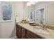 Bathroom featuring dual sinks, granite countertops, a large mirror, and ample lighting at 443 Lakeshore Ne Dr, Atlanta, GA 30307