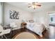 Bedroom featuring hardwood floors, a ceiling fan, and stylish decor at 443 Lakeshore Ne Dr, Atlanta, GA 30307
