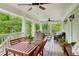 Spacious covered porch with a dining table, ceiling fans, and comfortable seating for outdoor enjoyment at 443 Lakeshore Ne Dr, Atlanta, GA 30307