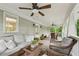 Relaxing covered porch boasts comfortable seating, ceiling fans, and views of the green landscape at 443 Lakeshore Ne Dr, Atlanta, GA 30307