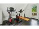 Bright exercise room featuring two stationary bikes and access to an outdoor deck at 443 Lakeshore Ne Dr, Atlanta, GA 30307