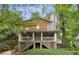 Charming two-story home featuring a spacious covered porch, shingle siding, and lush greenery all around at 443 Lakeshore Ne Dr, Atlanta, GA 30307