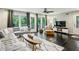 Bright living room with dark wood floors, comfortable seating, and sliding doors to the outdoor deck at 443 Lakeshore Ne Dr, Atlanta, GA 30307
