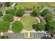 Aerial view reveals a circular green space with mature trees, seating, and a gazebo at 503 Mill Ridge Rd, Woodstock, GA 30188