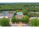 Aerial view showcases community pool, clubhouse, tennis courts surrounded by lush greenery and mature trees at 503 Mill Ridge Rd, Woodstock, GA 30188