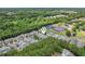 Aerial view of property nestled among lush greenery, tennis courts, and surrounding neighborhood at 503 Mill Ridge Rd, Woodstock, GA 30188