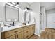 Bright bathroom with double sinks, a glass shower, and updated fixtures at 503 Mill Ridge Rd, Woodstock, GA 30188