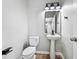 Half bath features a pedestal sink, sleek fixtures, and modern design at 503 Mill Ridge Rd, Woodstock, GA 30188
