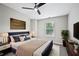 Well-lit bedroom featuring stylish decor, carpet flooring, and a ceiling fan at 503 Mill Ridge Rd, Woodstock, GA 30188