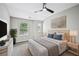 Well-lit bedroom featuring stylish decor, carpet flooring, and a ceiling fan at 503 Mill Ridge Rd, Woodstock, GA 30188