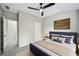 Well-lit bedroom featuring stylish decor, carpet flooring, and a ceiling fan at 503 Mill Ridge Rd, Woodstock, GA 30188