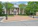 Beautiful brick clubhouse features stately white columns, manicured landscaping, and convenient parking at 503 Mill Ridge Rd, Woodstock, GA 30188