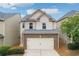 Charming home featuring a two-car garage, brick accents, and beautifully maintained landscaping at 503 Mill Ridge Rd, Woodstock, GA 30188