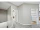 Upstairs hallway with gray walls and gray carpet, leading to laundry room and additional bedroom at 503 Mill Ridge Rd, Woodstock, GA 30188