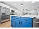 Bright kitchen featuring stainless steel appliances and a large island with a blue base at 503 Mill Ridge Rd, Woodstock, GA 30188