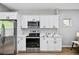 Modern kitchen with stainless steel appliances, white cabinets, and stylish backsplash at 503 Mill Ridge Rd, Woodstock, GA 30188