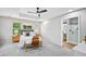 A primary bedroom with a tray ceiling, fan, and ensuite bathroom at 503 Mill Ridge Rd, Woodstock, GA 30188