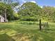 Expansive green land with mature trees, rustic fencing, and potential for building or recreation at 7000 Petersburg Rd, Fairburn, GA 30213