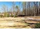 Large backyard features a charming stone fire pit perfect for outdoor gathering and a secure wood fence at 109 Lighthorse Blvd, Mcdonough, GA 30252