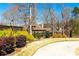 View of the home's lush backyard, landscaped with mature trees and manicured shrubs at 109 Lighthorse Blvd, Mcdonough, GA 30252