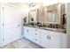 Beautiful bathroom with double sinks, granite countertops, and decorative mirrors at 109 Lighthorse Blvd, Mcdonough, GA 30252