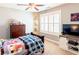 Comfortable bedroom with a dresser, TV, and shutters at 109 Lighthorse Blvd, Mcdonough, GA 30252