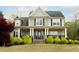 Charming two-story home featuring a welcoming front porch and well-manicured landscaping at 109 Lighthorse Blvd, Mcdonough, GA 30252
