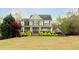 Beautiful two-story home with a green lawn and mature trees, offering a serene setting at 109 Lighthorse Blvd, Mcdonough, GA 30252