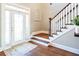 Bright foyer with stairs, dark wood floors, decorative window, and glass front door at 109 Lighthorse Blvd, Mcdonough, GA 30252