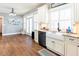 Modern kitchen with white cabinetry, granite countertops, and a stylish farmhouse sink at 109 Lighthorse Blvd, Mcdonough, GA 30252