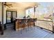 Covered outdoor kitchen featuring wood counters, a bar, and two Big Green Egg ceramic charcoal grills at 109 Lighthorse Blvd, Mcdonough, GA 30252