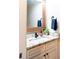 Stylish powder room featuring granite countertops, wood framed mirror and modern fixtures at 109 Lighthorse Blvd, Mcdonough, GA 30252