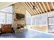 Screened sunroom featuring a stone fireplace, wood flooring, and a ceiling fan at 109 Lighthorse Blvd, Mcdonough, GA 30252