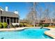 Backyard view featuring the in-ground swimming pool, deck, and screened in porch at 109 Lighthorse Blvd, Mcdonough, GA 30252