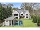 A spacious backyard featuring a refreshing pool, pool house, and expansive green lawn at 258 Pineland Nw Rd, Atlanta, GA 30342