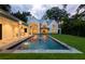 Beautiful backyard with a pool, a built-in spa, an outdoor kitchen, and lush green lawn at 258 Pineland Nw Rd, Atlanta, GA 30342